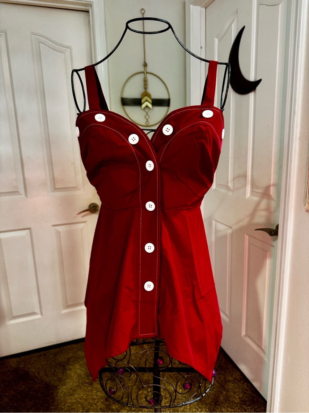 Red Sleeveless Blouse with Handkerchief Hemline and Contrasting White Buttons